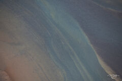 An aerial abstract photograph of Iceland's colourful Ölfusá river