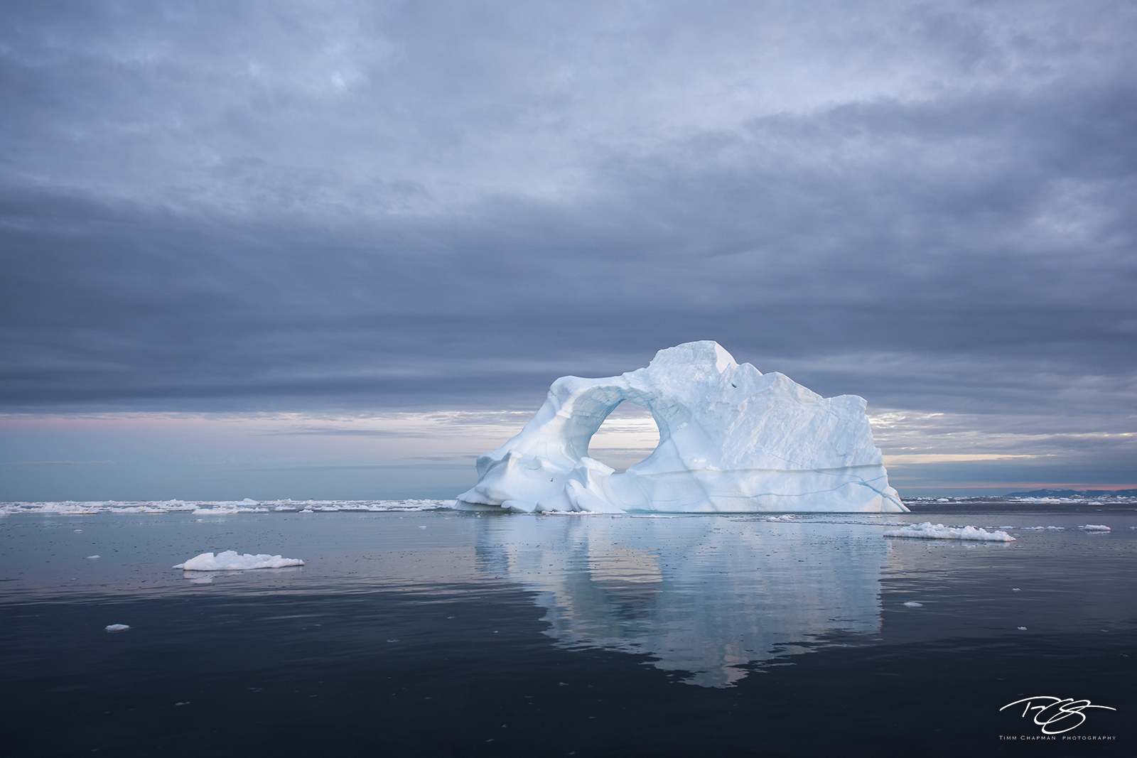 Arctic Mirror An ice arch floats silently in Greenland's Disko Bay