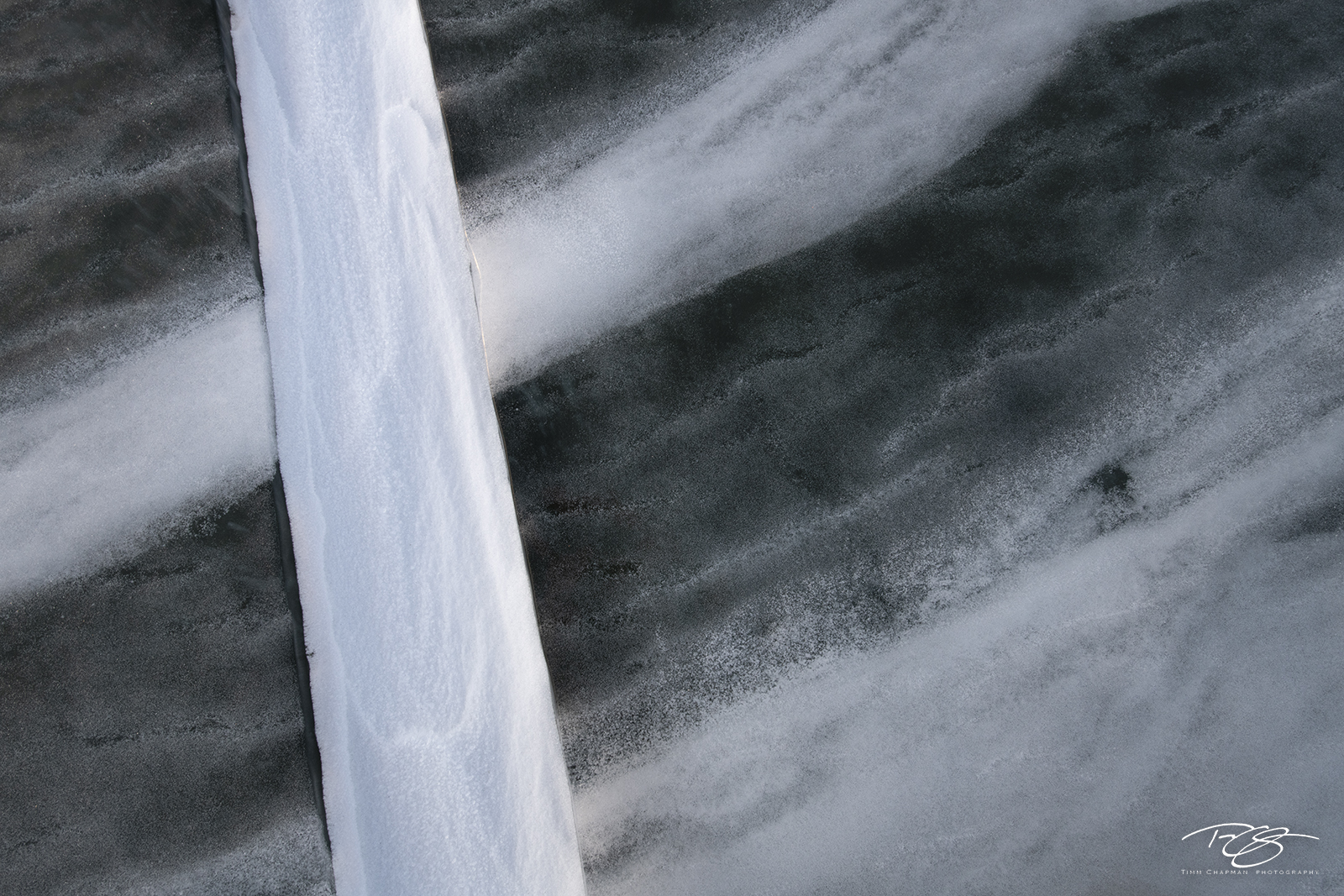Baikal Abstract 1 A snowstorm during the freezing of the Maloe Mare Strait creates a granite type appearance in the ice, whilst a crack filled...