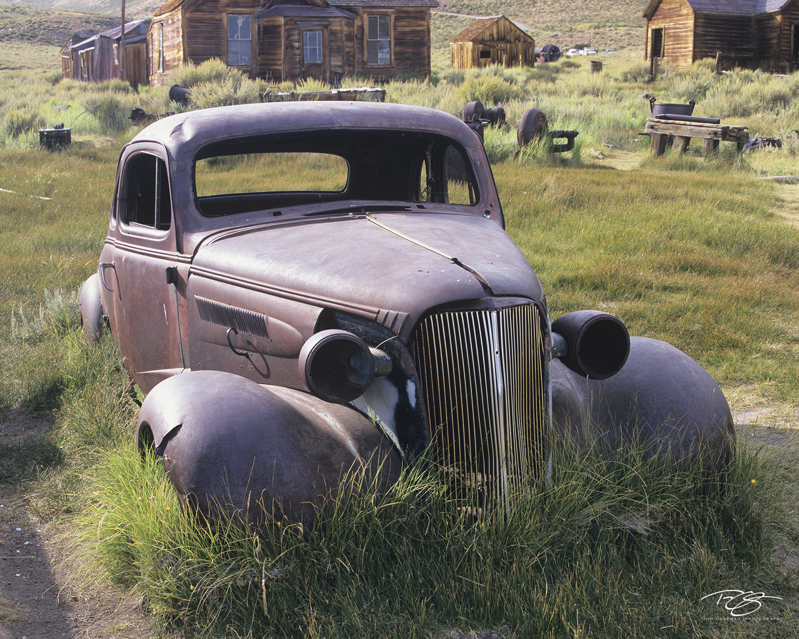 The Forgotten Coupe An abandoned 37 Chevrolet Coupe lies forgotten in the field of a deserted town high atop a mountain in Northern California
