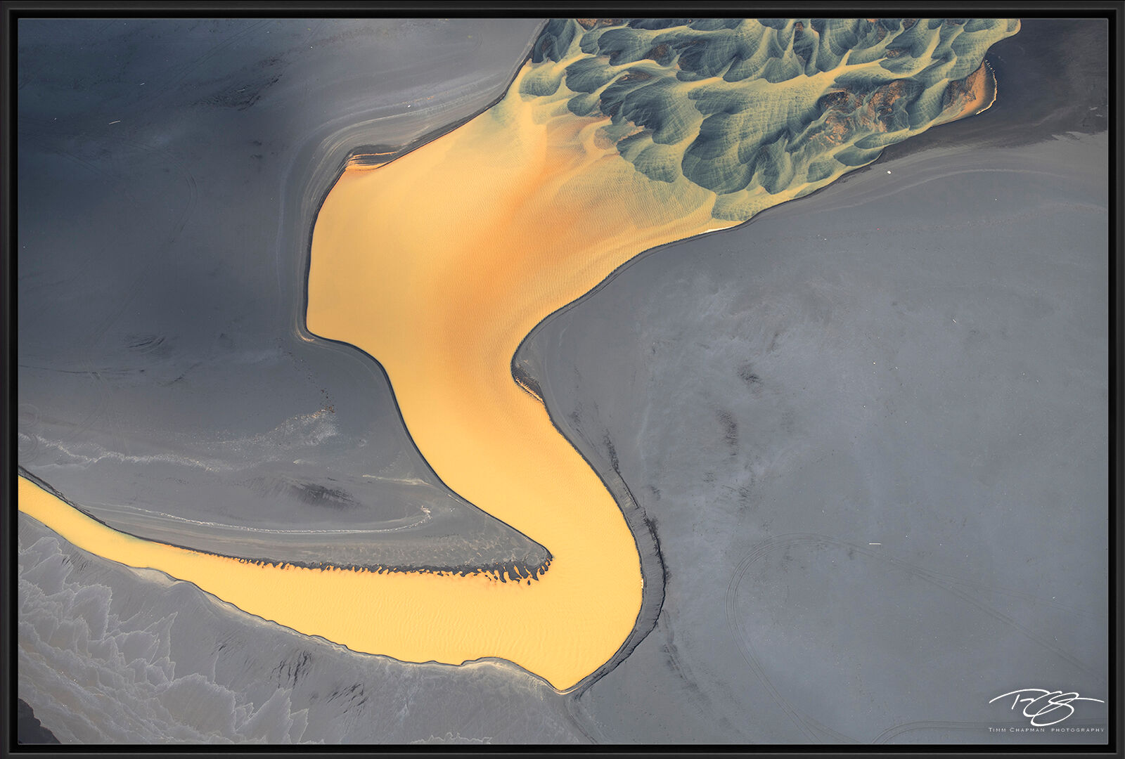 Fusion Aerial view of Icelandic waterway, the Þjórsá River as it winds across the black sand beach, mixing with...