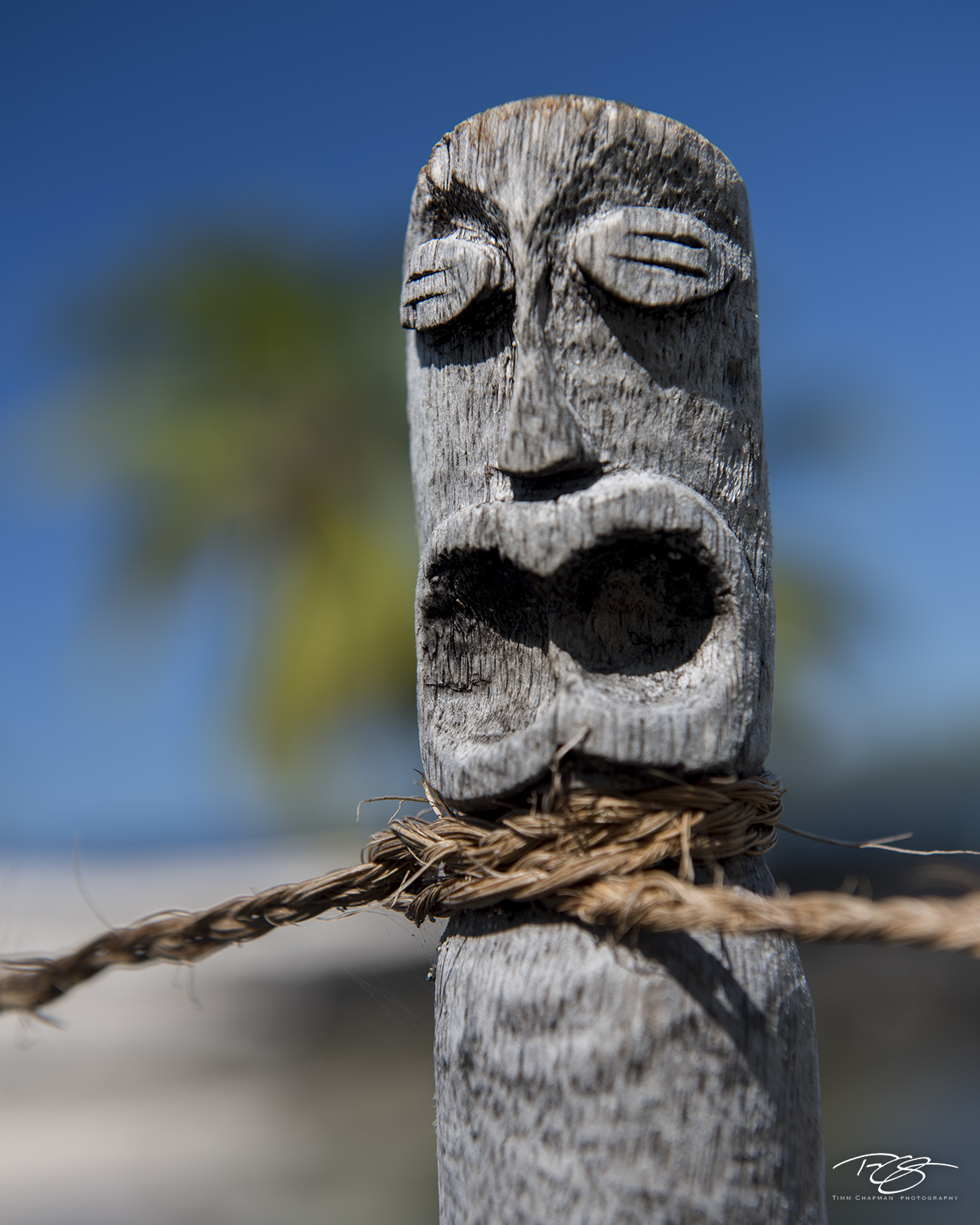 Gak!! A clever tiki carving is used as a fence post on the big island of Hawaii