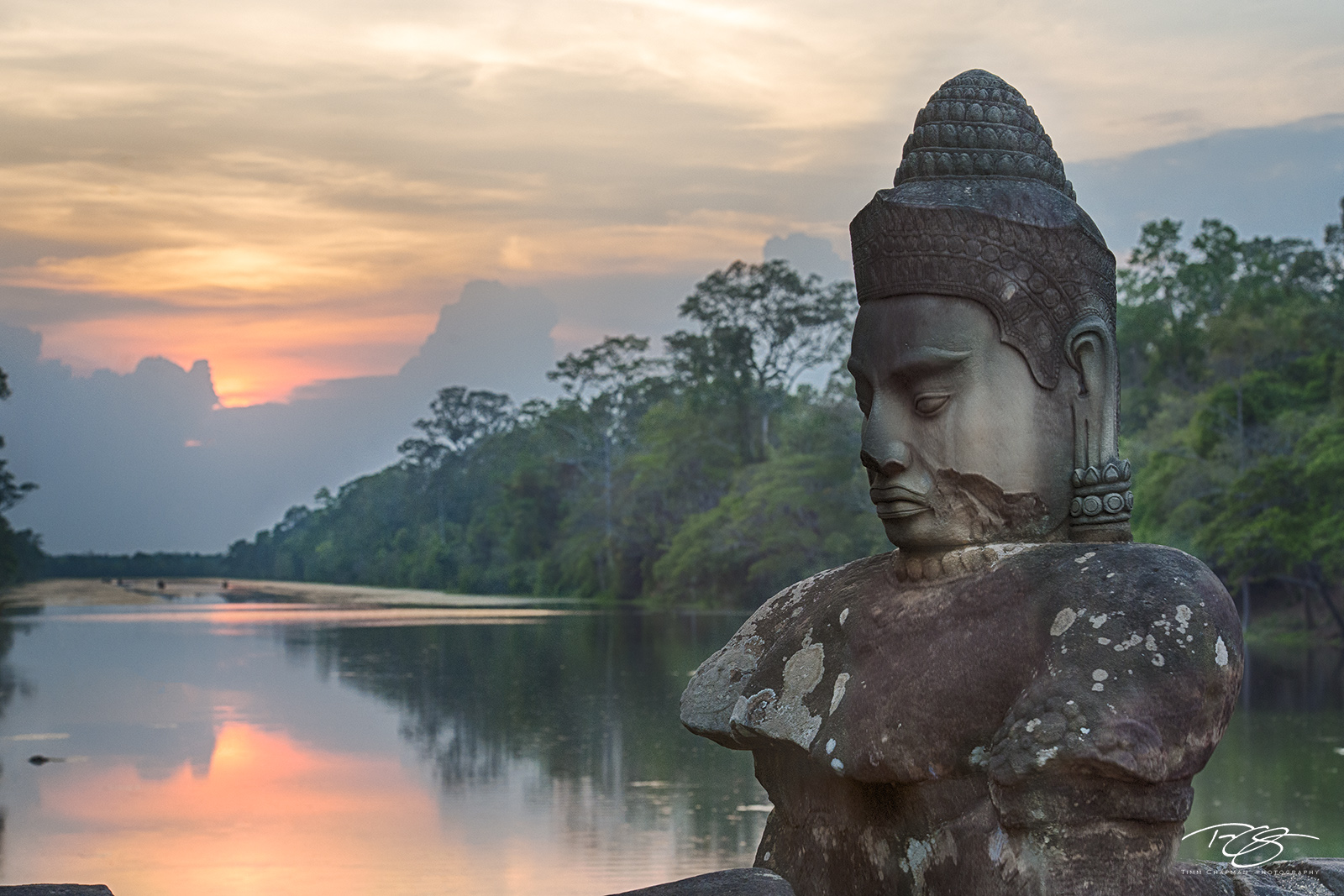 Guardian of the Causeway A statue of Buddha joins a line of other gods manning the causeway over the Siem Reap river leading to the gateway to the Angkor...