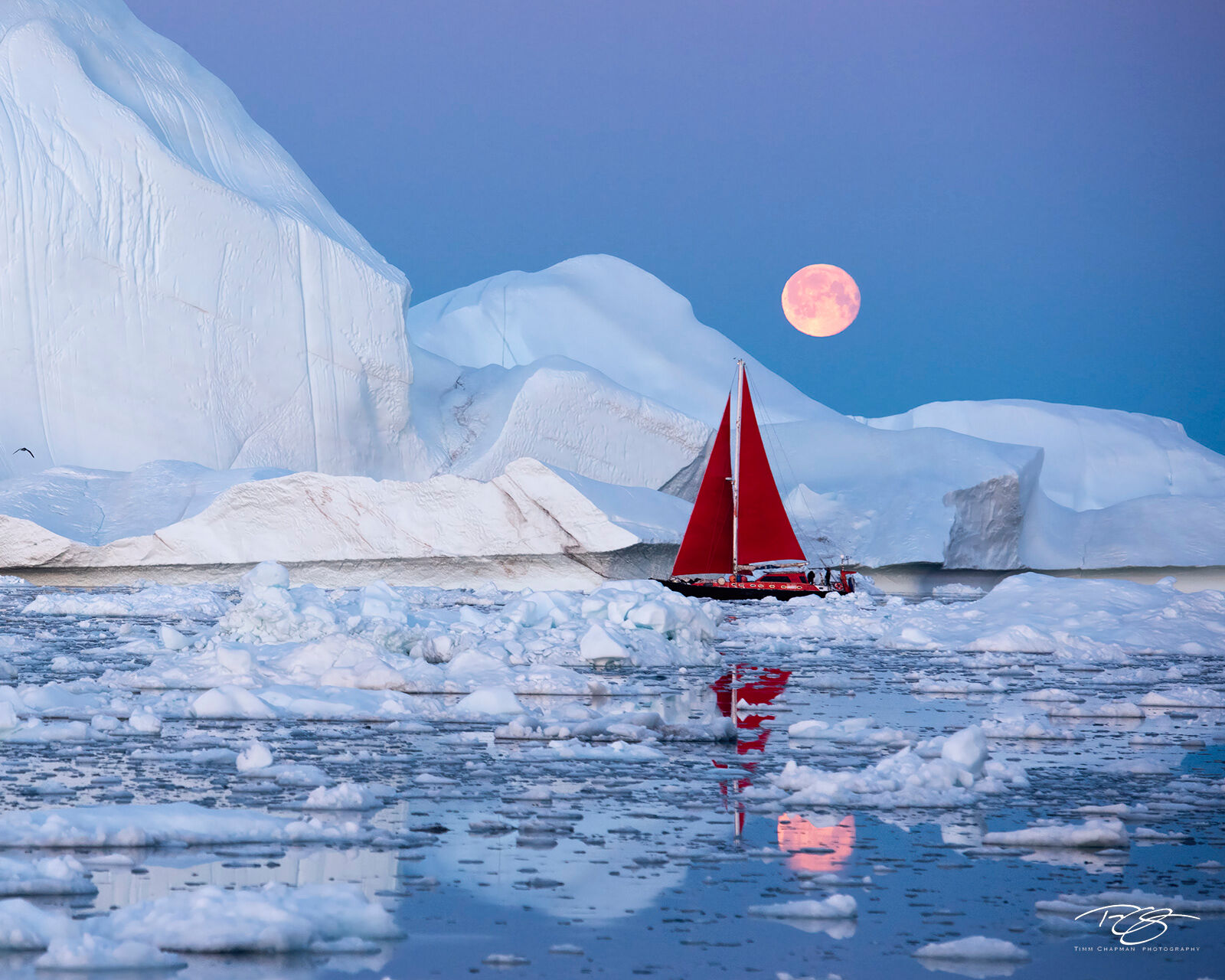 Moondance A sailboat navigates the ice-choked Disko Bay under the watch of a full moon