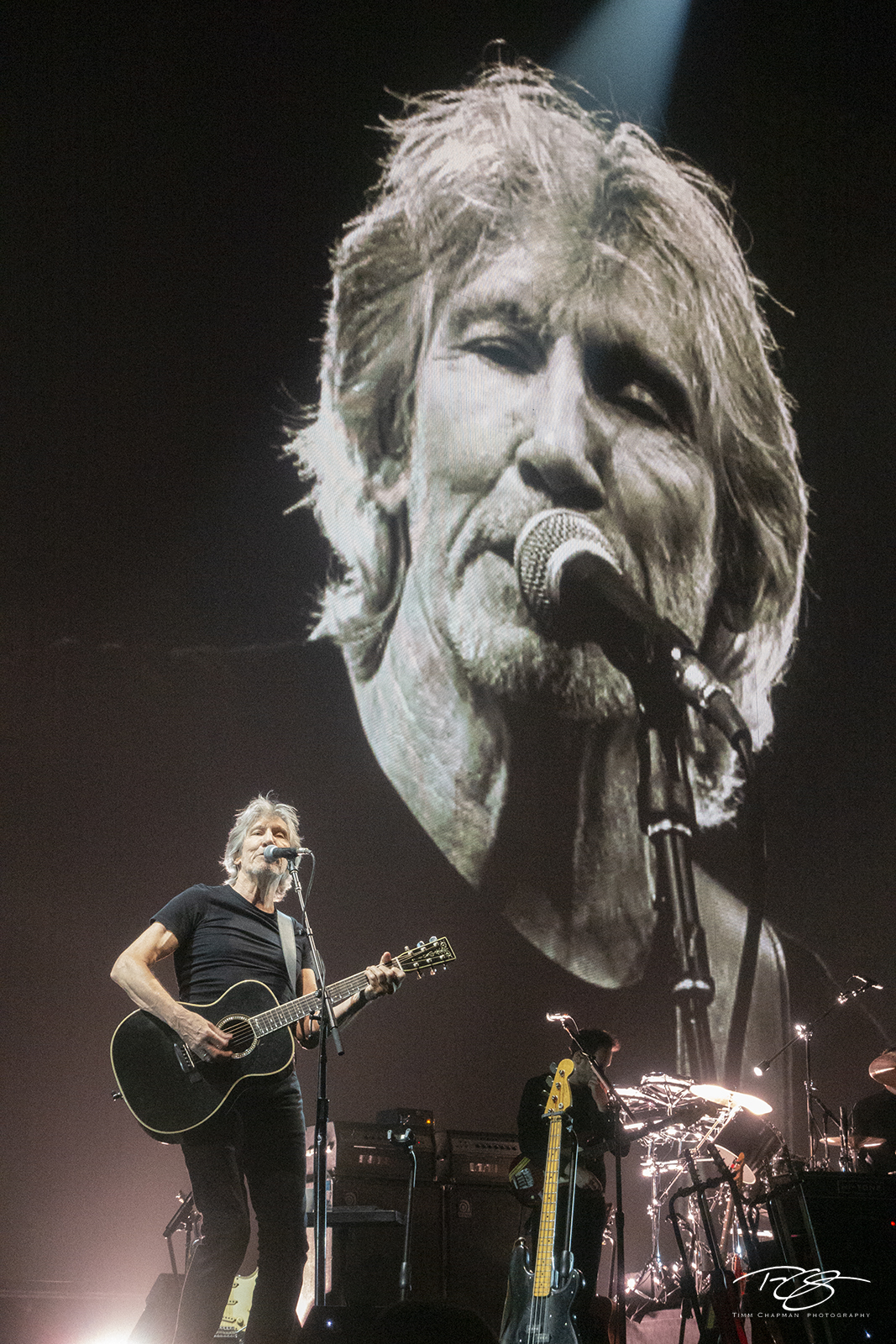 Overseeing Roger Waters performs on the acoustic guitar during the US + Them tour