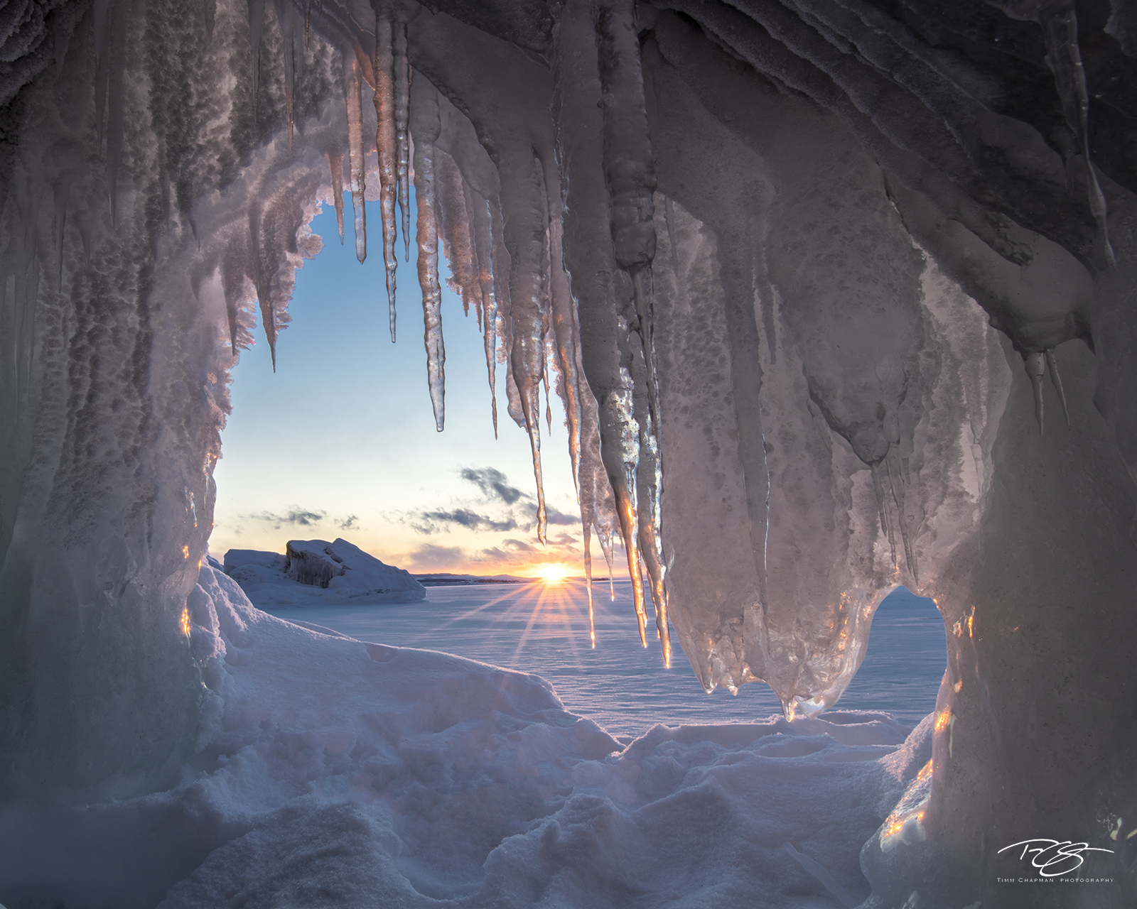 The Last Rays The setting sun casts its last warm rays into an ice cave