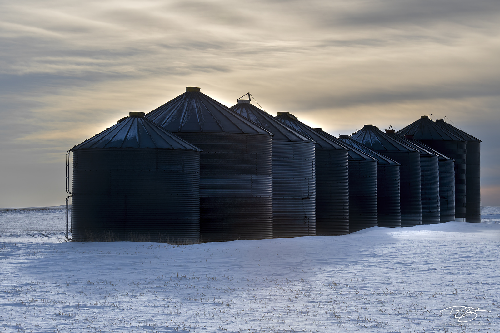 The Queue A long line of grain silos huddle together for warmth under the cold, brooding winter sky