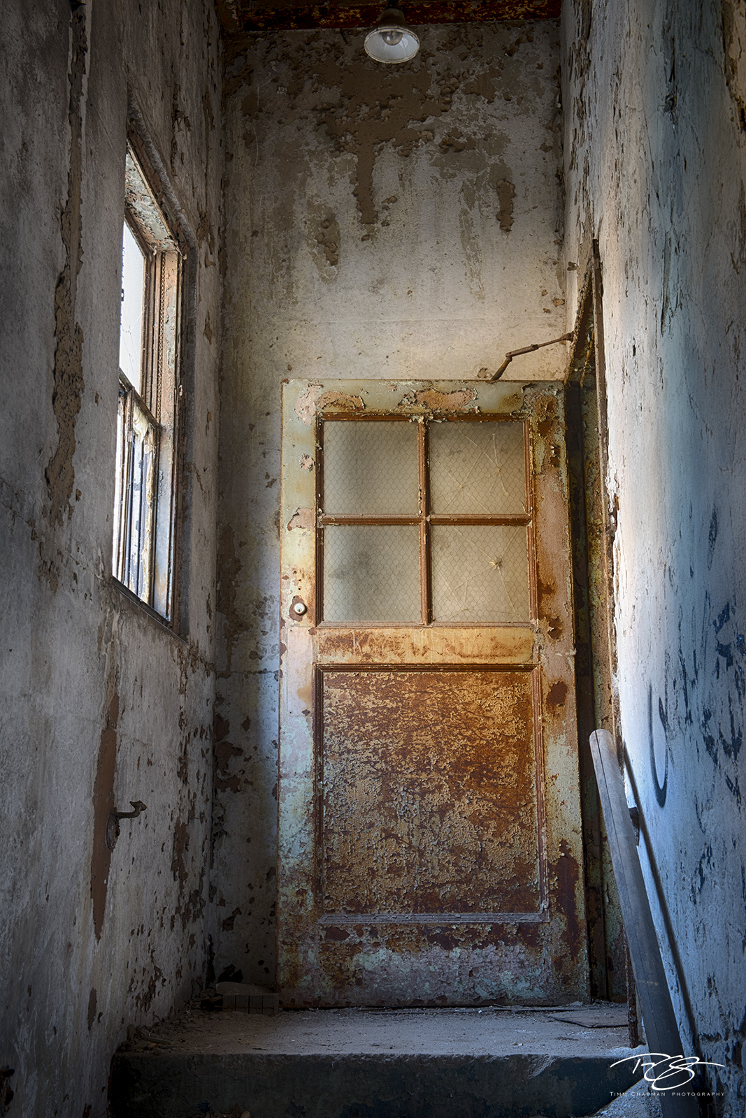The Landing A rusted security door opens to reveal a way out of an old stairwell
